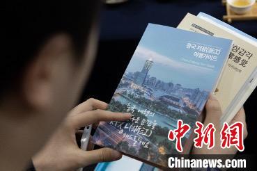 參展觀眾閱讀浙江文旅手冊(cè)?！《≌裾?攝