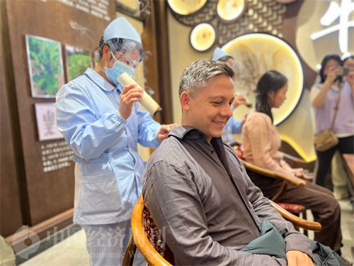   （外媒記者體驗艾灸。中國經(jīng)濟周刊記者 郭志強 攝）