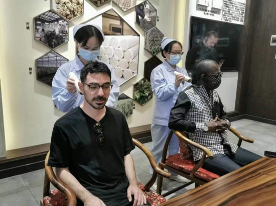 2023“一帶一路”媒體合作論壇聯(lián)合采訪團(tuán)團(tuán)員在九牛草展示館體驗(yàn)艾灸。（本報(bào)記者 黃超攝）