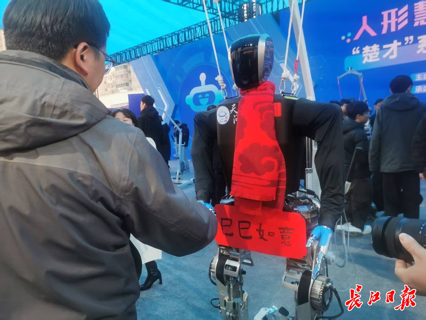 “天問”人形機(jī)器人和參觀市民握手，互致新年快樂。 長江日報(bào)記者陳永權(quán) 攝