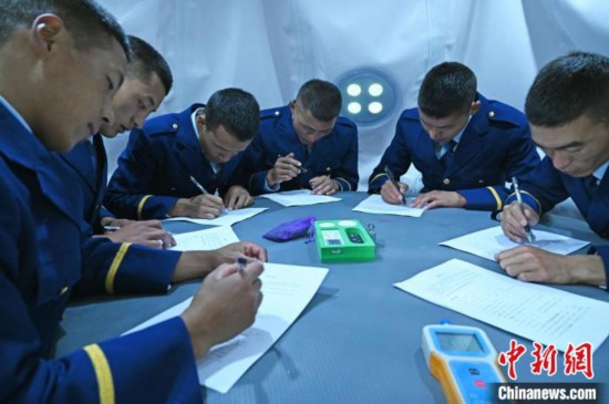 圖為消防員在高壓氧艙內(nèi)填寫問卷?！≮w朗 攝