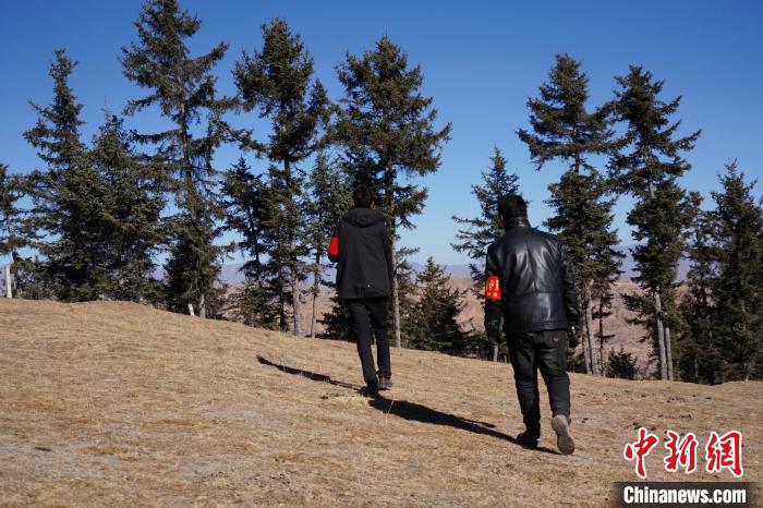 圖為桑杰加(左)和同事巡查林場?！●R銘言 攝