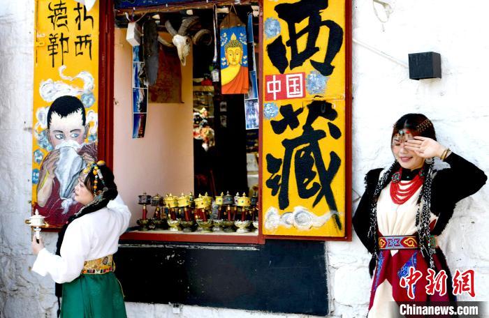 4月17日，游客身著藏式元素服裝在拉薩八廓街拍照留念?！±盍?攝
